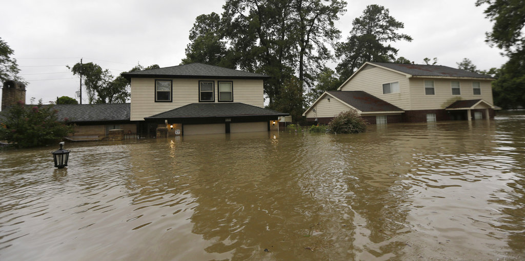 Floodwaters from Tropical Storm Harvey surround homes Monday, Aug. 28, 2017, in Spring, Texas. (AP Photo/David J. Phillip)