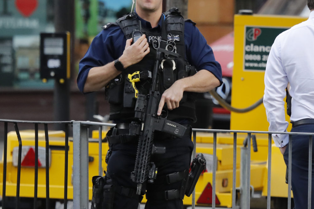 An armed police officer stands nearby after an incident on a tube train at Parsons Green subway station in London, Friday, Sept. 15, 2017. A reported explosion at the train station sent commuters stampeding in panic, injuring several people on Friday at the height of London's morning rush hour, and police said they were investigating it as a terrorist attack. (AP Photo/Frank Augstein)