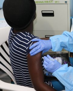 Women recieves injection of ebola vaccine in office setting