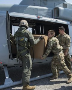 US soldiers load suppplies onto helicopter