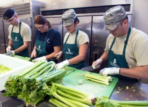 Airmen volunteer to prepare meals for the homeless at the Pine Street Inn, one of the shelters in Boston.